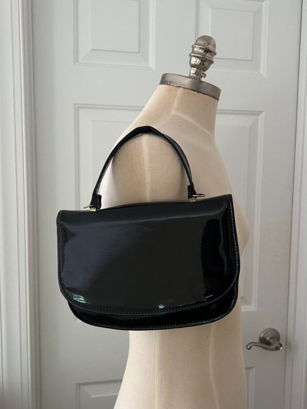 Black patent leather handbag with gold hardware
